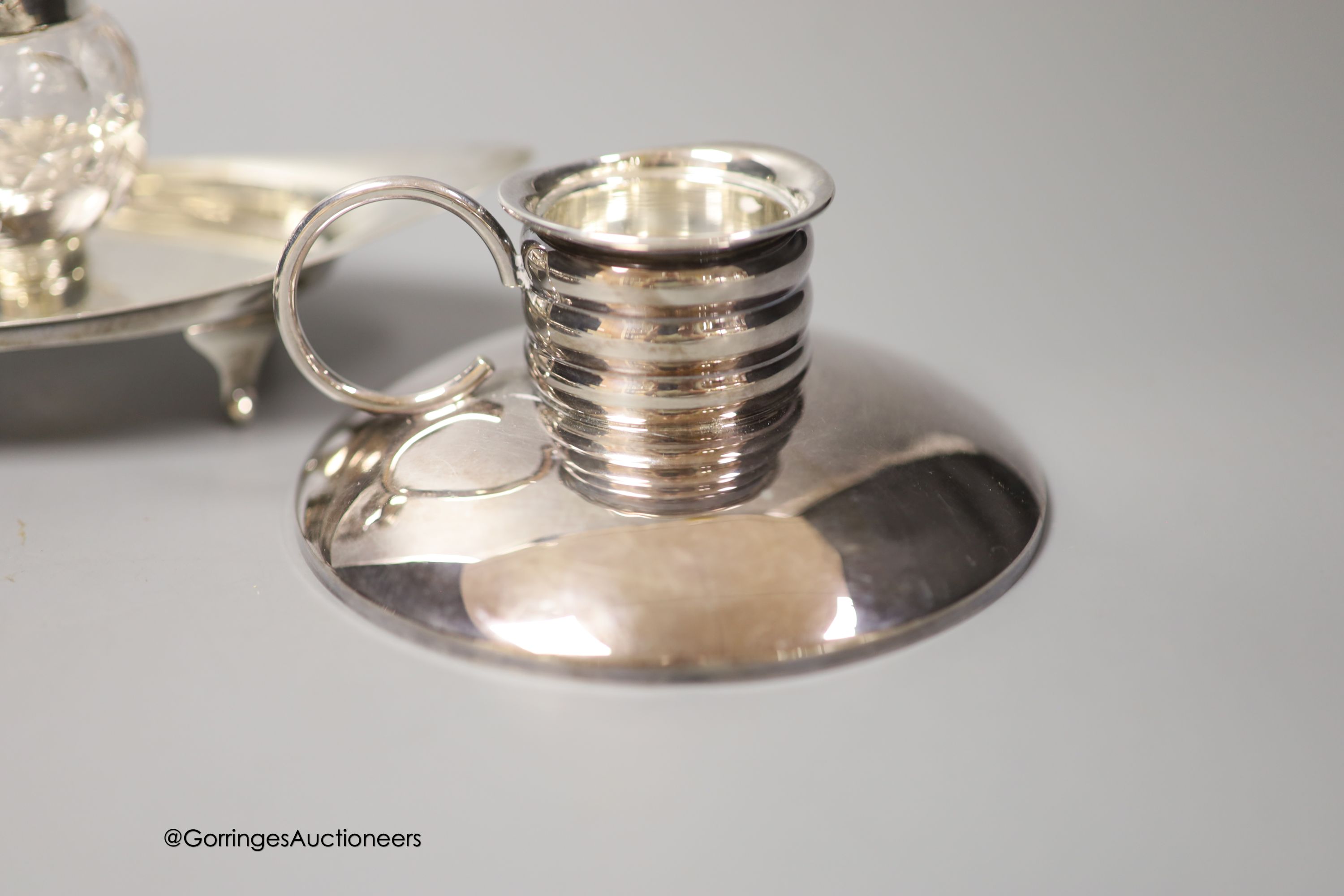 An Edwardian silver navette shaped inkstand, with single well, Birmingham, 1903, 17.5cm, a small modern silver presentation dish and an early 20th century German 835s white metal mounted chamberstick, by Gayer & Krauss.